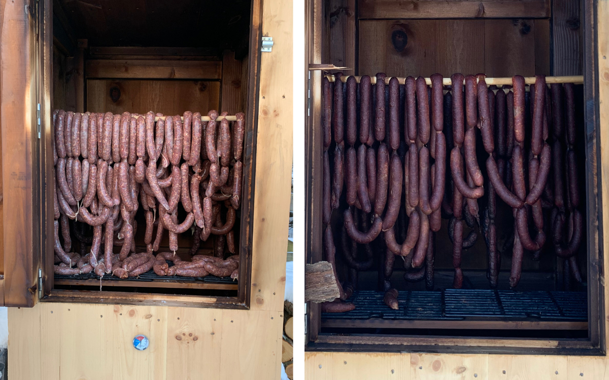 Venison sausages hang in the cold smoker.